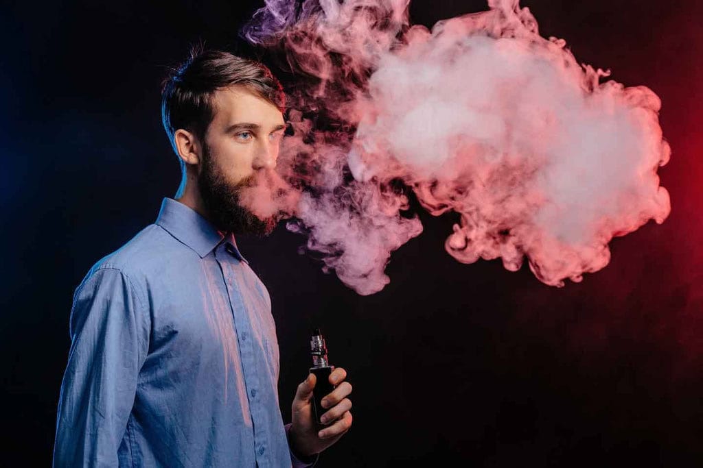 To vape or not to vape? To the medical community, the benefits are clear 2 Man vaping rainbowvapes e-liquid